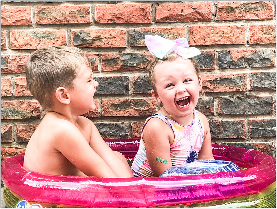 toddler boy and girl playing with gellibaff from zimpli kids in swimming pool